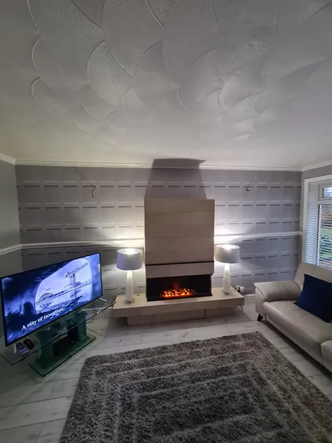 Grey sitting room with a decorated fireplace wall