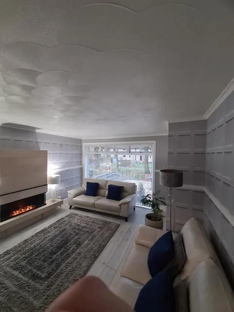 Grey living room with a painted ceiling and fireplace