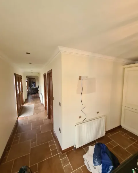 Cream-painted hallway and radiator wall with white cornicing