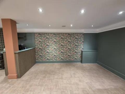 Green room with a floral feature wall and white painted ceiling