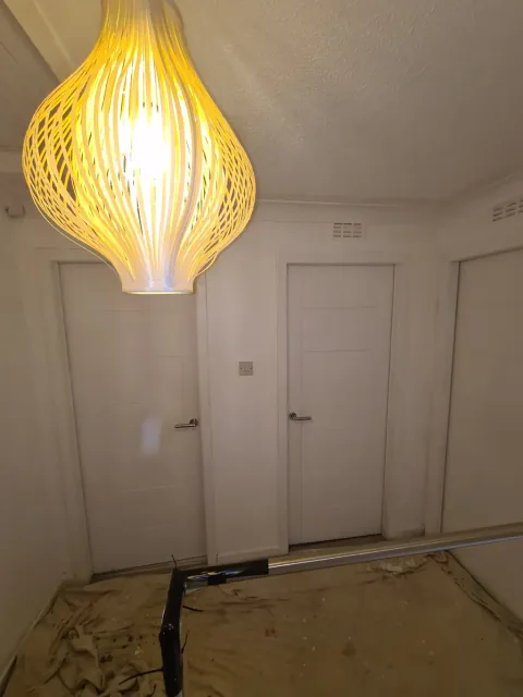 Neutral room with a pendant light and painted doors