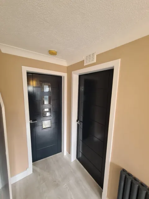 Interior doorways with black doors and white trim