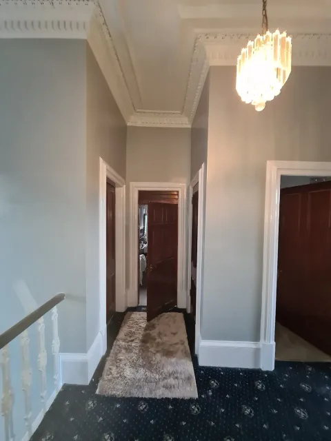 White ceiling and cornicing in a traditional hallway