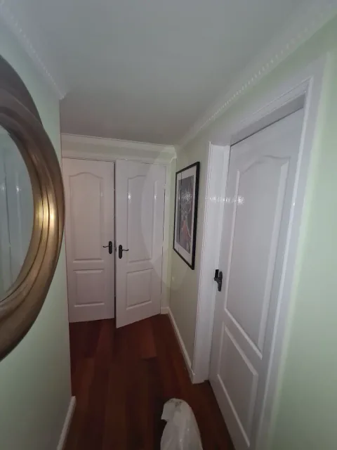 Light hallway with white doors and painted woodwork
